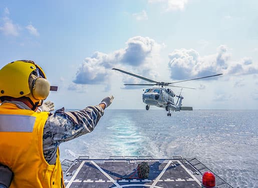 military helicopter landing at sea